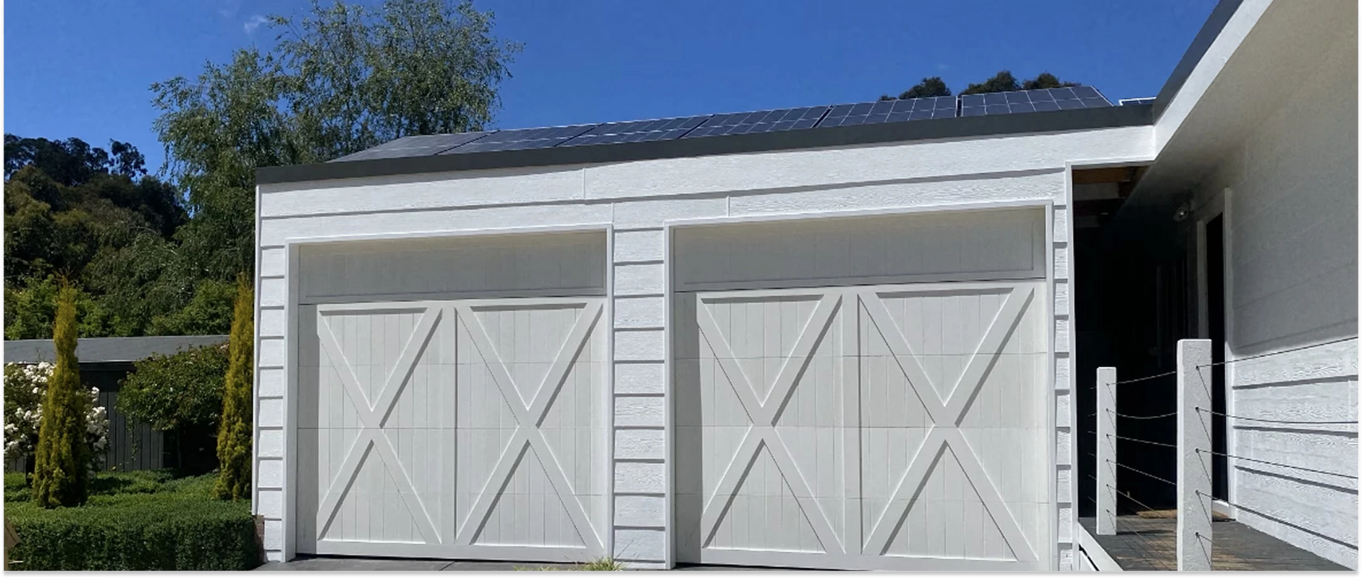 Black roll-up shutter on a brick building with a protruding frame.